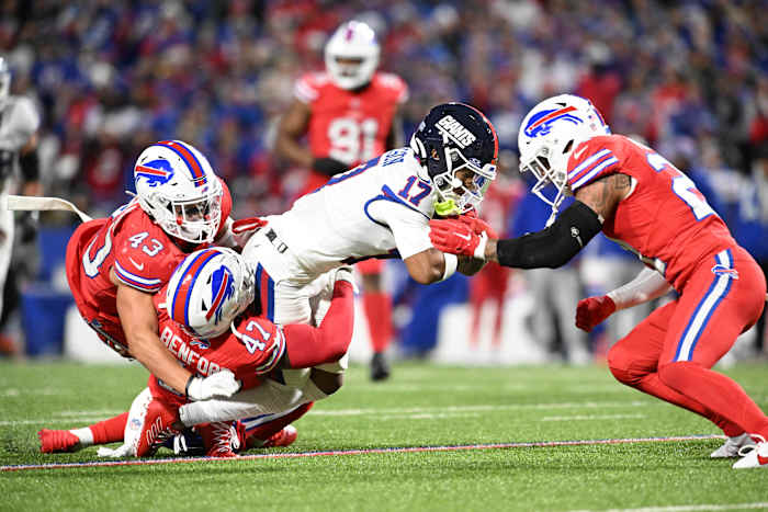 New York Giants wide receiver Wan'Dale Robinson (17) is tackled by Buffalo Bills cornerback Christian Benford (47) and linebacker Terrel Bernard (43) and safety Jordan Poyer (21)